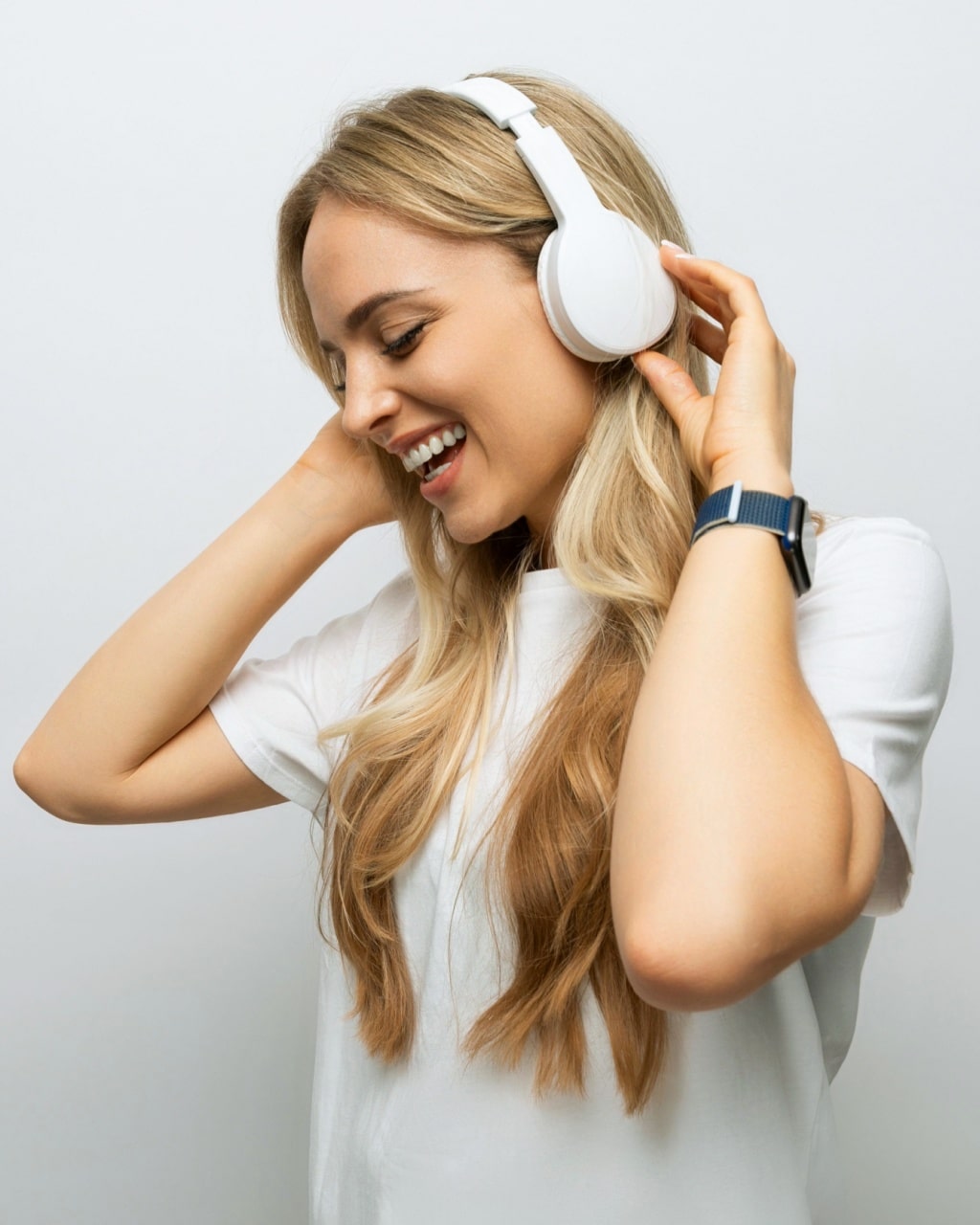 woman sings along to music from headphones
